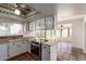Bright kitchen with Saltillo tile and white cabinets, open to the sunroom at 4527 E Sunrise Dr, Phoenix, AZ 85044