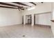 Large living space with Saltillo tile, ceiling fan, recessed lighting, and arched entryways to adjoining rooms at 4527 E Sunrise Dr, Phoenix, AZ 85044
