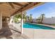 Covered patio view of the sparkling blue swimming pool and backyard at 4527 E Sunrise Dr, Phoenix, AZ 85044