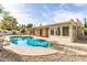Backyard view of the beautiful kidney shaped pool and patio with a view of the home's exterior windows and door entries at 4527 E Sunrise Dr, Phoenix, AZ 85044