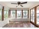 Bright sunroom with Saltillo tile, ceiling fan, expansive windows, and views of the backyard pool at 4527 E Sunrise Dr, Phoenix, AZ 85044