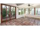 Charming sunroom featuring Saltillo tile, windows, and a glass-paneled door at 4527 E Sunrise Dr, Phoenix, AZ 85044