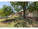 Lush backyard with mature trees, a covered patio, and manicured lawn at 4535 E Redfield Rd, Phoenix, AZ 85032