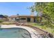 Backyard view featuring the pool, patio area, and mature trees at 4535 E Redfield Rd, Phoenix, AZ 85032