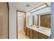 Well-lit bathroom with double sinks and a shower with glass doors at 4535 E Redfield Rd, Phoenix, AZ 85032