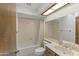 Bright bathroom with a shower-tub combination and a large vanity mirror at 4535 E Redfield Rd, Phoenix, AZ 85032