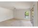 Spacious bedroom with neutral carpet, ceiling fan, and access to the backyard at 4535 E Redfield Rd, Phoenix, AZ 85032
