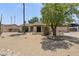 Charming single-story home with desert landscaping, mature tree, and an inviting facade at 4535 E Redfield Rd, Phoenix, AZ 85032
