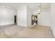 Open-concept living room with neutral carpet, modern lighting, and seamless flow to other rooms at 4535 E Redfield Rd, Phoenix, AZ 85032