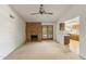 Living room with a brick fireplace and patio doors, offering a cozy and inviting space at 4535 E Redfield Rd, Phoenix, AZ 85032