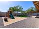 This backyard features a playset, trampoline, and gravel at 4624 S Fair Ln, Tempe, AZ 85282