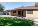 This backyard features artificial grass and a covered patio at 4624 S Fair Ln, Tempe, AZ 85282
