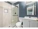 Bathroom featuring walk-in shower, sink, and modern black fixtures at 4624 S Fair Ln, Tempe, AZ 85282