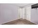 This carpeted bedroom features a closet, tv, and views into the home at 4624 S Fair Ln, Tempe, AZ 85282