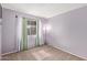 This carpeted bedroom features a light fixture and window with curtains at 4624 S Fair Ln, Tempe, AZ 85282