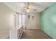 Bedroom with turquoise panel accent wall, ceiling fan and large window at 4624 S Fair Ln, Tempe, AZ 85282