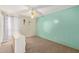 Bedroom with turquoise paneled accent wall, ceiling fan, and natural light at 4624 S Fair Ln, Tempe, AZ 85282