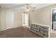 Bedroom featuring neutral walls, ceiling fan and large white dresser for storage at 4624 S Fair Ln, Tempe, AZ 85282