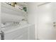 This laundry room features modern appliances and convenient shelfing at 4624 S Fair Ln, Tempe, AZ 85282
