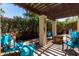 Inviting back patio seating area with pergola, fire pit, and lush greenery for outdoor enjoyment at 4812 E Winston Dr # 2, Phoenix, AZ 85044