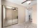 Cozy bedroom featuring carpeted floors, a closet with mirrored doors, and a ceiling fan at 4812 E Winston Dr # 2, Phoenix, AZ 85044