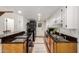 Functional galley kitchen featuring dark countertops, tile floors, and white cabinets for a clean design at 4812 E Winston Dr # 2, Phoenix, AZ 85044