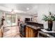 Open kitchen area with dark countertops, wood cabinets, and views into the bright, spacious living room at 4812 E Winston Dr # 2, Phoenix, AZ 85044