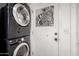 Efficient laundry area with stacked washer and dryer, complemented by a unique zebra art piece at 4812 E Winston Dr # 2, Phoenix, AZ 85044
