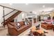 Cozy living room with a rustic staircase, comfortable seating, and an open-concept design to the kitchen at 4812 E Winston Dr # 2, Phoenix, AZ 85044