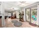 Bright and open living room featuring wood-look floors, large sliding glass doors, and a full wall mirror at 4812 E Winston Dr # 2, Phoenix, AZ 85044