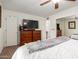 Spacious main bedroom with neutral paint, a ceiling fan, and dresser at 4812 E Winston Dr # 2, Phoenix, AZ 85044