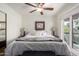 Bright main bedroom featuring a ceiling fan, sliding glass door, and neutral paint at 4812 E Winston Dr # 2, Phoenix, AZ 85044