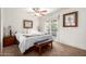 Comfortable main bedroom features neutral paint, a ceiling fan, and a side table at 4812 E Winston Dr # 2, Phoenix, AZ 85044