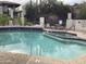 Community swimming pool with clear blue water, hot tub, tables, and lounge chairs at 4812 E Winston Dr # 2, Phoenix, AZ 85044