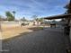 Wide view of the backyard, featuring grilling area, picnic table, and partially-covered patio at 538 E Glade Ave, Mesa, AZ 85204