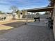 Spacious backyard featuring a covered patio, brick pavers, grilling area, and block fence at 538 E Glade Ave, Mesa, AZ 85204
