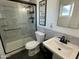 Well-lit bathroom featuring a glass-enclosed shower, toilet and sink at 538 E Glade Ave, Mesa, AZ 85204