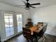 Bright dining area features a ceiling fan and access to the backyard through double doors at 538 E Glade Ave, Mesa, AZ 85204