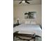 Bright bedroom with a ceiling fan, bench, and art at 6145 E Cave Creek Rd # 203, Cave Creek, AZ 85331