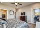 Spacious bedroom with access to a patio, complemented by a ceiling fan and a decorative art piece at 6145 E Cave Creek Rd # 203, Cave Creek, AZ 85331