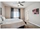 A large bedroom with curtains, carpet, ceiling fan, and door to a walk-in closet at 6145 E Cave Creek Rd # 203, Cave Creek, AZ 85331