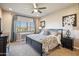 Comfortable bedroom featuring a ceiling fan, neutral tones, and a picturesque view from the window at 6145 E Cave Creek Rd # 203, Cave Creek, AZ 85331