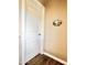 Hallway with a white door, wood floor, and wall décor at 6145 E Cave Creek Rd # 203, Cave Creek, AZ 85331