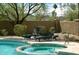 Large hot tub beside the swimming pool with lounge chairs and landscaping at 6145 E Cave Creek Rd # 203, Cave Creek, AZ 85331