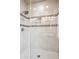 Modern shower with tiled walls, lighting, and glass door at 6145 E Cave Creek Rd # 203, Cave Creek, AZ 85331
