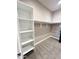 Walk-in closet featuring built-in shelving, carpet and rod, ensuring organized storage within the space at 6145 E Cave Creek Rd # 203, Cave Creek, AZ 85331