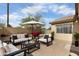 Inviting patio area with lounge furniture, perfect for relaxing outdoors under an umbrella at 6410 W Winslow Ave, Phoenix, AZ 85043