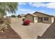 Backyard with gravel landscaping, block wall, with desert flowers and home exterior in view at 6410 W Winslow Ave, Phoenix, AZ 85043