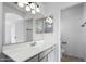 Modern bathroom featuring a gray vanity, a large mirror and a separate toilet room at 6410 W Winslow Ave, Phoenix, AZ 85043