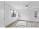 Bright bedroom with carpet features a ceiling fan and multiple windows at 6410 W Winslow Ave, Phoenix, AZ 85043